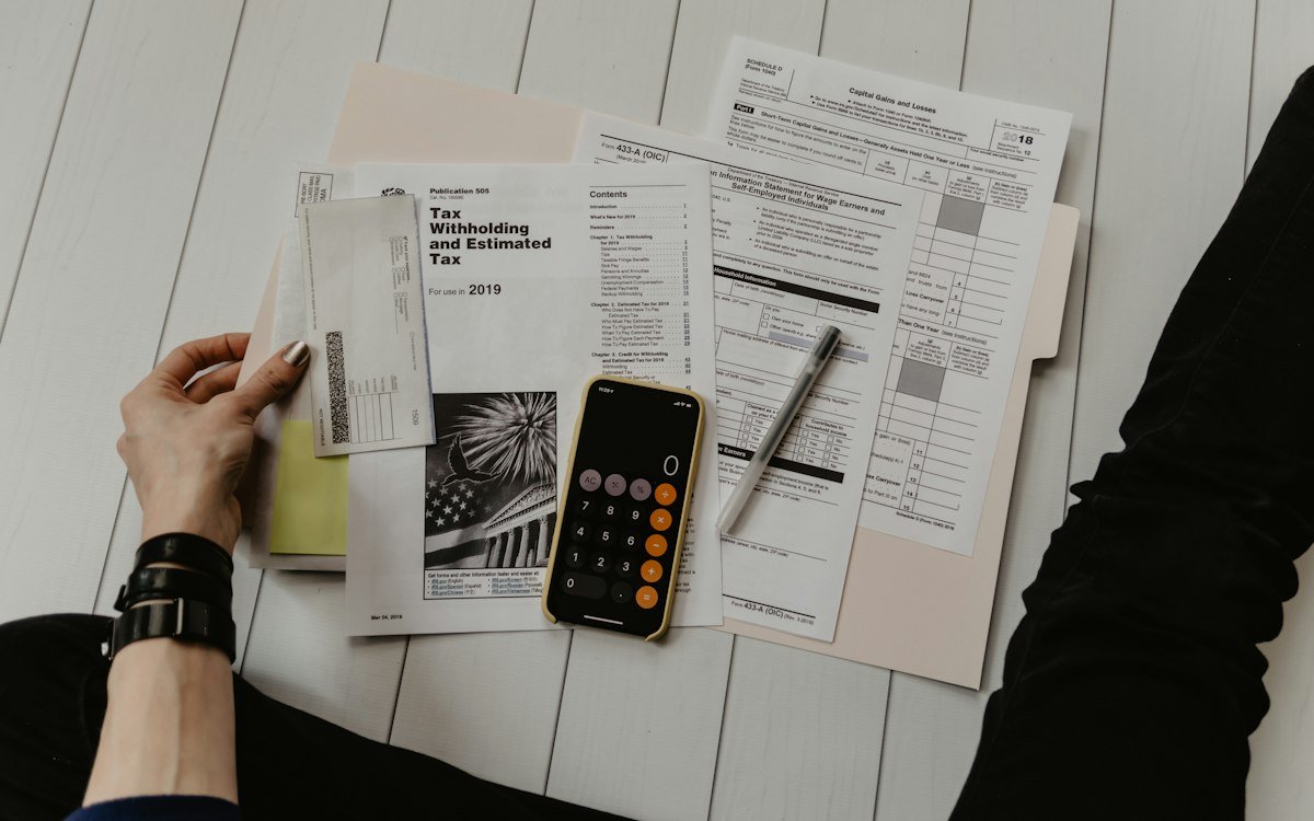 Accountant working with financial documents and a calculator at a desk