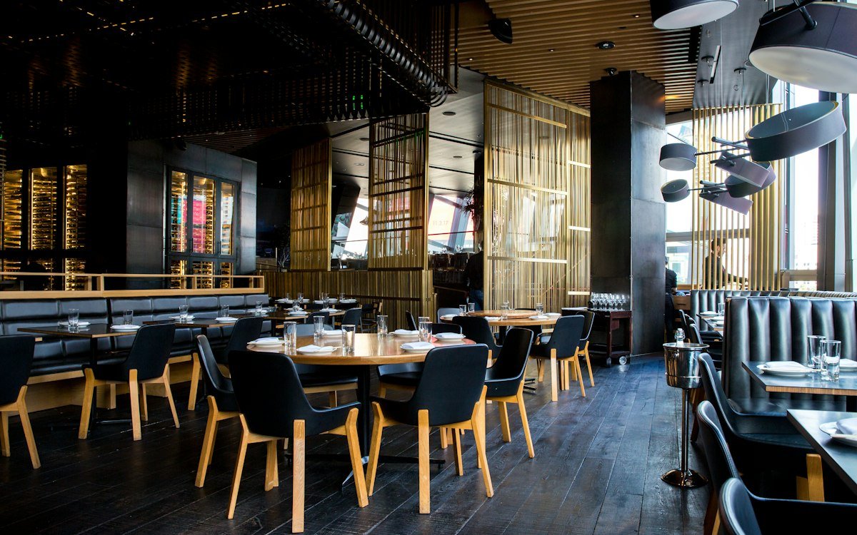 Warm restaurant interior with wooden tables and soft evening light