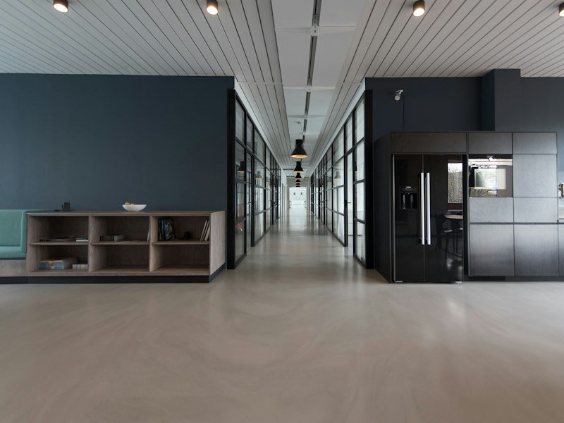 Quiet professional office with desks, bookshelves, and soft window light