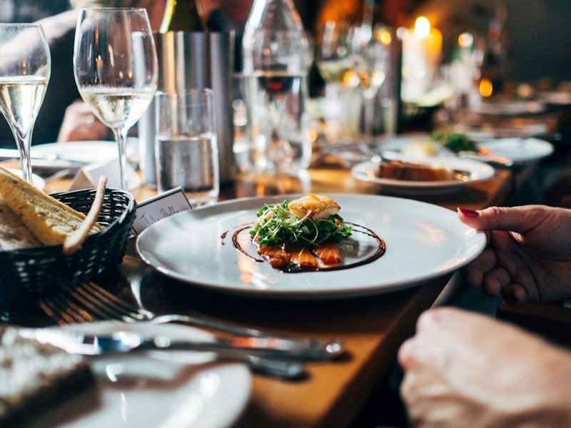 Restaurant dining room with set tables, warm lights, and calm atmosphere